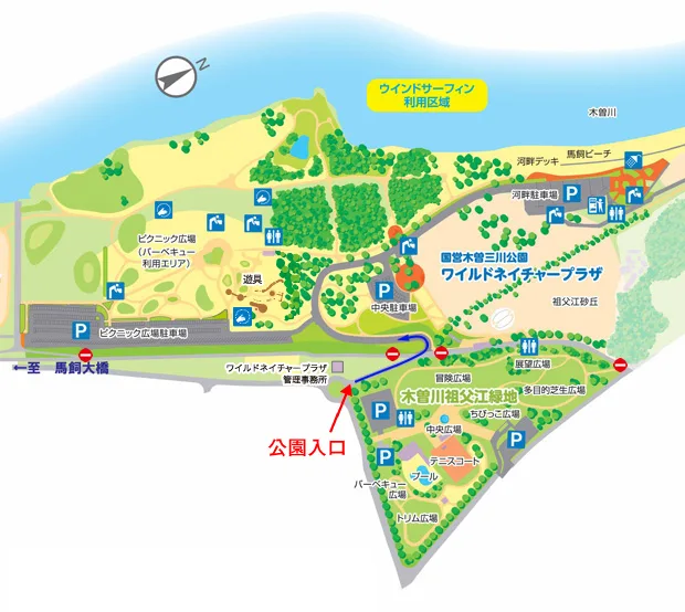 サリオパーク祖父江の施設案内図。木曽川沿いに国営木曽三川公園ワイルドネイチャープラザ、木曽川祖父江緑地、祖父江砂丘などのエリアが色分けして描かれ、駐車場と公園入口の位置が矢印付きで示されている。